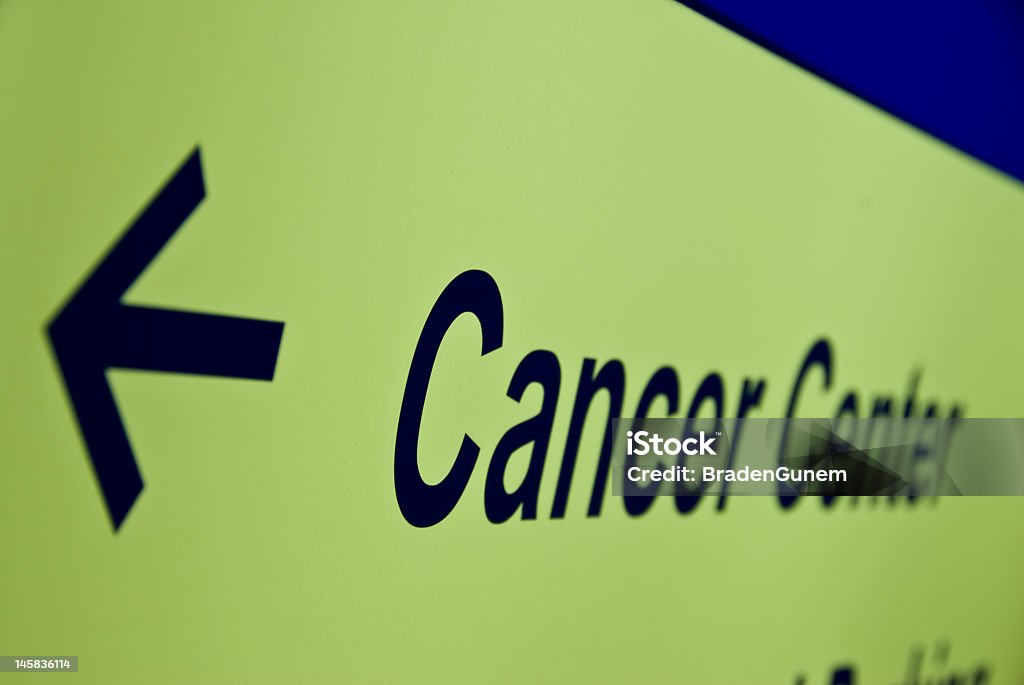 Close-up of a sign and arrow leading to the cancer center An arrow sign marking the entrance to a cancer treatment center. American Culture Stock Photo