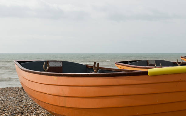 wooden rowing boats on the beach stock photo