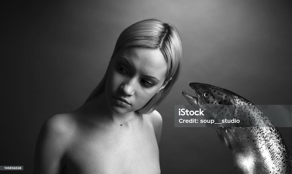 fashionable girl with big fish fashionable elegant girl with big fish on dark background Adolescence Stock Photo
