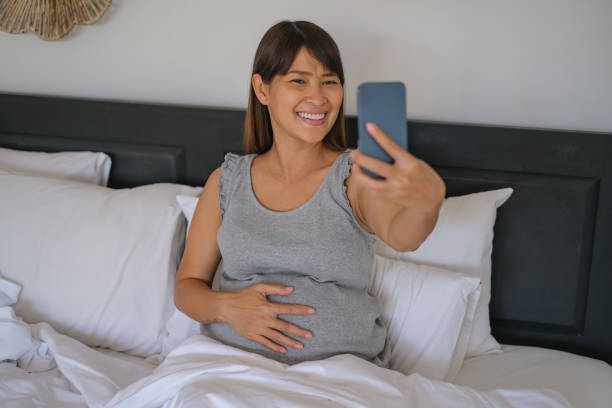 istock Beautiful Pregnant Woman Using Phone For Video Call 1458367232