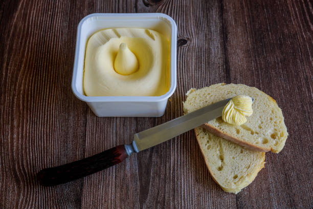 istock On slice of bread creamy butter is spread. 1458370668
