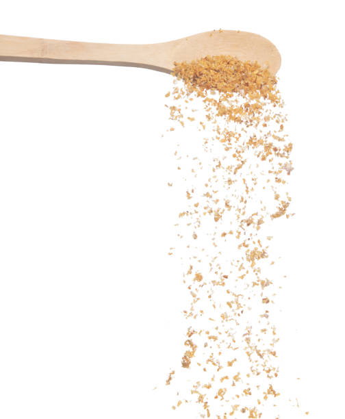 istock Fried Garlic pour fall down from wooden spoon, golden yellow fried garlic float abstract fly. Beautiful fried garlic splash stop in air, food object design. White background isolated high speed freeze 1458371963