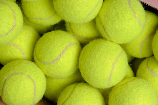 istock green tennis balls on cardboard box 1458372445