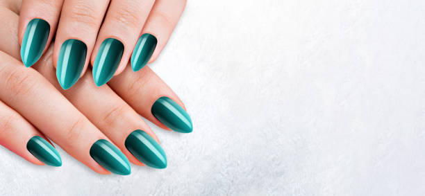 istock Womans hands with trendy light blue manicure on white background. Colorful nail design 1458373926