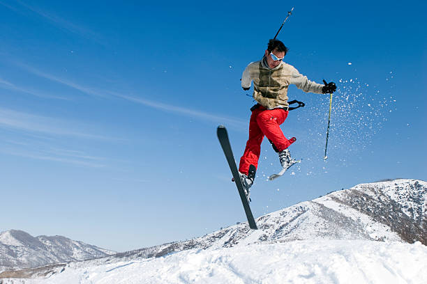 Snow Skier Jumping Against Blue Sky in Tien Shan
