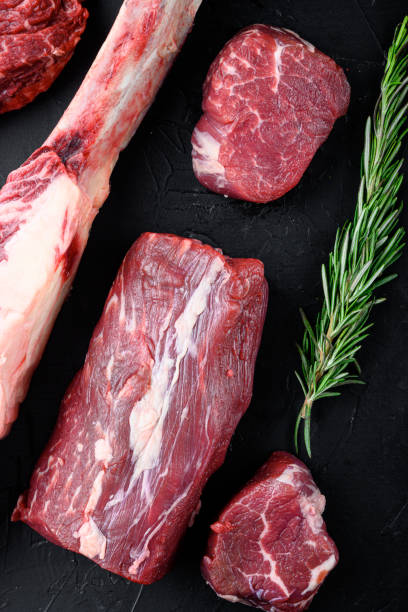 istock Beef fillet mignon cut raw, on black stone background, top view flat lay 1458375724
