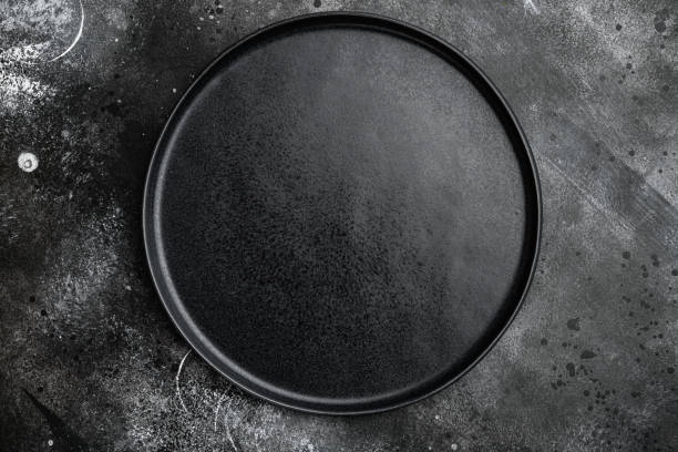 istock Top view of black plate, on black dark stone table background 1458378945