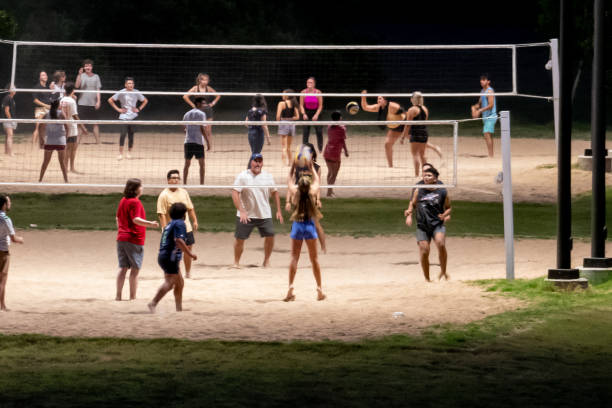 Texas college students play a friendly game of volleyball at san gabriel park in georgetown, texas on 6-10-2023. A player is captured on film jumping for the ball