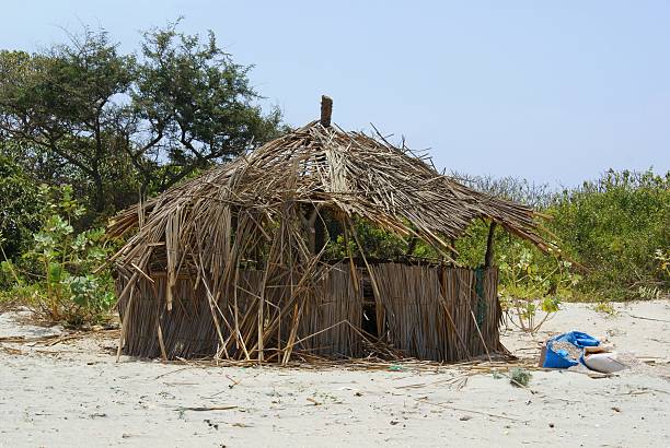 abandoned beach hut An abandoned hut on the beach in The Gambia. (SONY DSC) thatched roof hut straw grass hut stock pictures, royalty-free photos & images