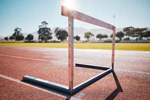 Empty stadium, field and running hurdle or barrier at outdoors race track. Sports, athletics or jumping obstacle, metal equipment for runners or athletes for competition, exercise or training outside