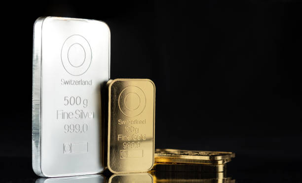 istock A 500 gram silver bar and several gold bars on a black 1458399360