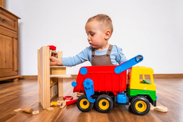 istock A two-year-old boy playing car mechanic. 1458401383