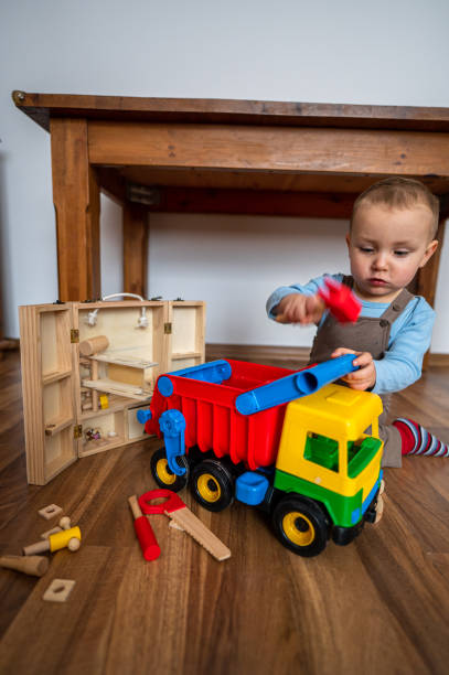 istock A two-year-old boy playing car mechanic. 1458402637