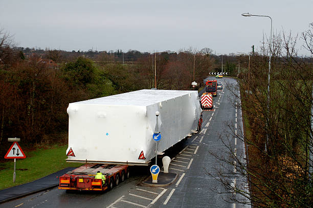 istock Long lorry carrying a wide load down a road 145840553