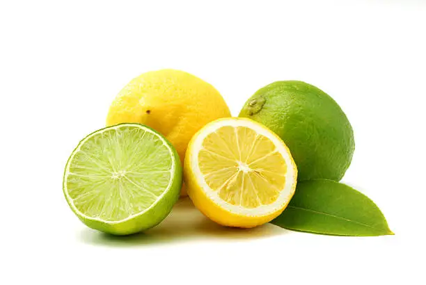 Close up of lemons and green limes isolated over white
