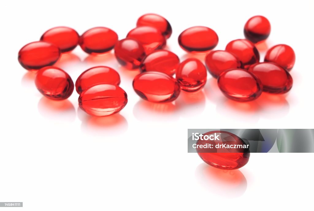 Red capsules Red capsules on white background Addiction Stock Photo