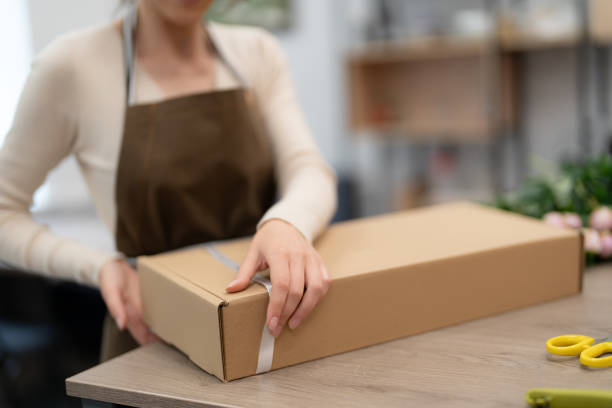 istock Florist working with flowers making a composition ghift box 1458414617