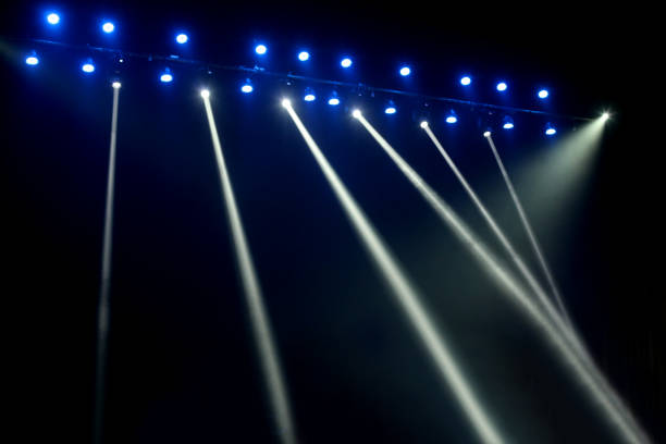 istock Blue and white concert stage lights on black background 1458414880