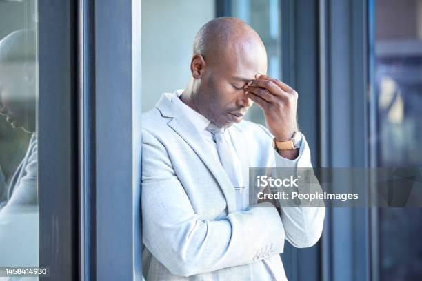 Stress Headache And Tired African Businessman Outside The Office Taking A Break From Work Frustrated Burnout And Overworked Professional Manager Working Overtime At His Workplace In The Urban City Stock Photo - Download Image Now