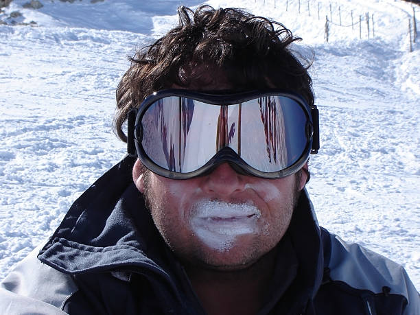 Avoiding sun burn while skiing Skier with excessive sun block on his lips, avoiding damage from the powerful sun rays while on the slopes. ski goggles stock pictures, royalty-free photos & images