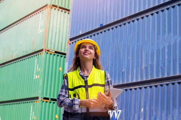 istock Caucasian female worker using a tablet to check cargo at a container shipping company. The concept of logistics worldwide cargo container 1458418220