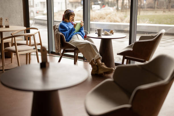 istock Woman works on touchpad at coffee shop 1458419939