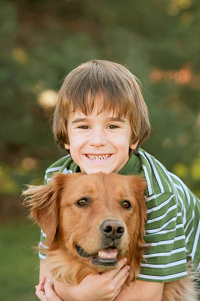 istock Boy Hugging Golden Retriever 145842065
