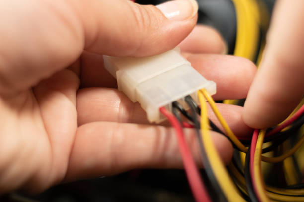 istock Close-up hand holding wires in internet network systems 1458420833