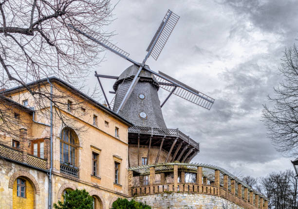 Potsdam, Germany - January 02, 2023: Ancient traditional wooden wind mill near the Sanssouci Royal Palace and Park in Potsdam. Famous landmark in Germany