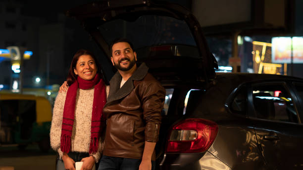 istock Happy young couple at night standing roadside 1458422731