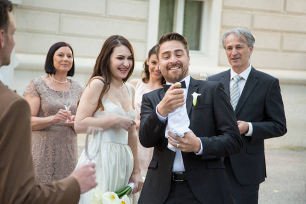 istock Groom opening champagne on his wedding 1458423362