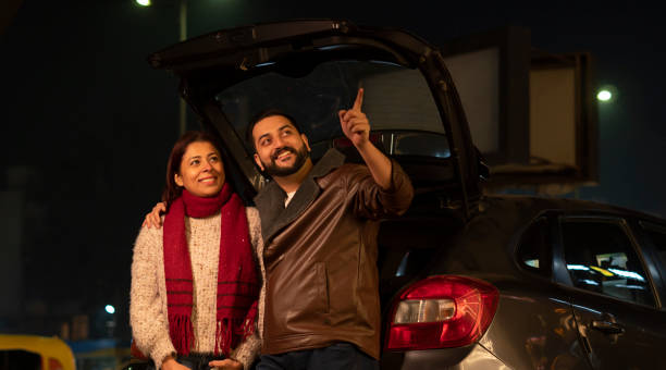 istock Happy young couple at night standing roadside 1458423887