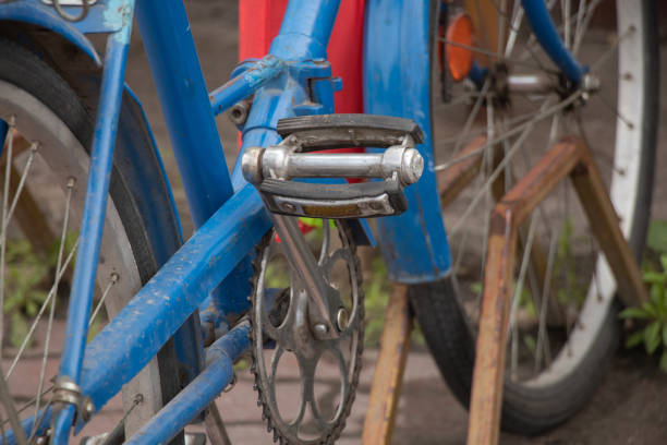old blue bicycle stands in the yard close-up, retro bicycle