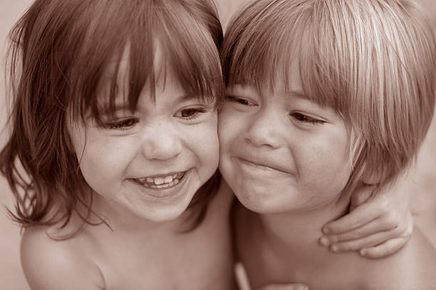 istock twin brother and sister hugging smiling 145842455