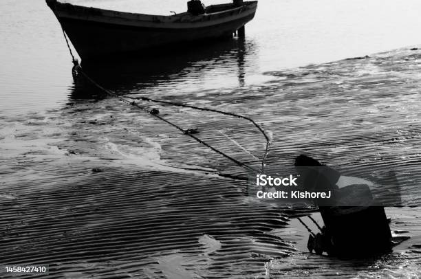 Monochrome Black And White Photograph Of Moored Fishing Vessel On Alibaug Beach On Western Coast Of Maharashtra State India Stock Photo - Download Image Now