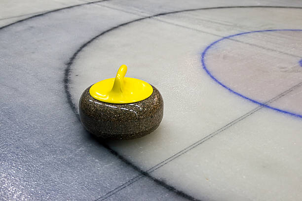 Curling stone on the Ice stock photo