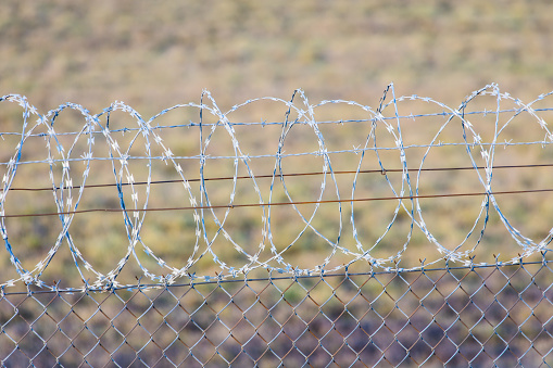 A wire fence and barbed wire at Eindhoven Airport