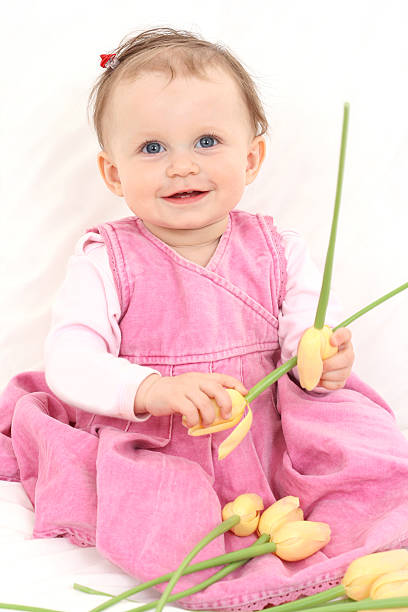 istock baby girl with flowers 145843209