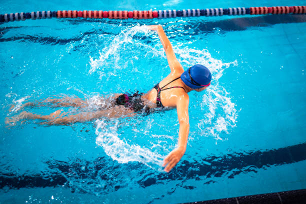 istock Girl swimming in the pool 1458434409