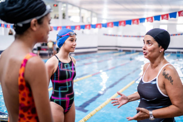 istock Teacher explaining to kids in the poolside 1458434755