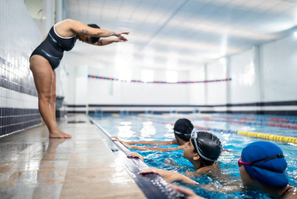 istock Teacher in a swimming class in the pool 1458436192