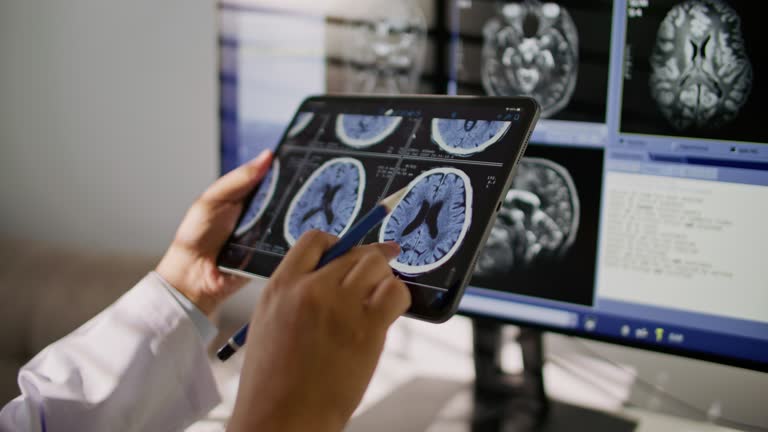Doctor Looking CT examination image at Digital tablet