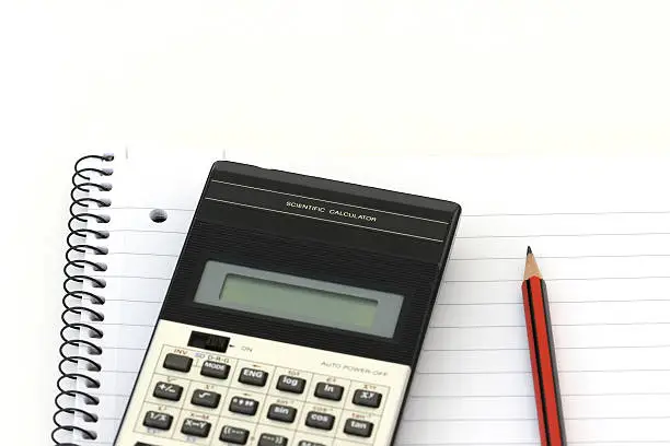 A calculator and pencil on a writing pad.