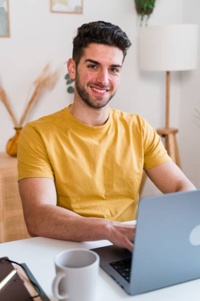 istock Happy man working on laptop 1458440520