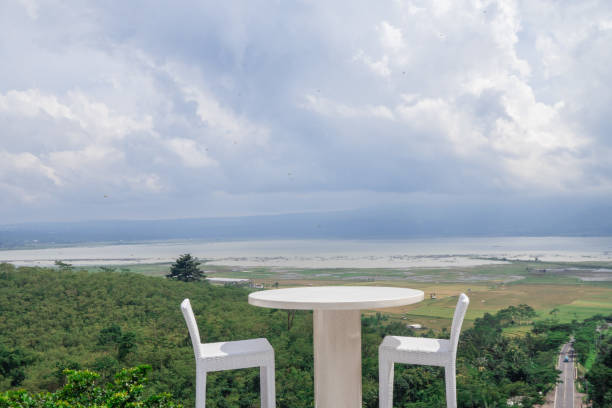 istock Empty white chair and table with beautiful background and cloudy sky. 1458441211