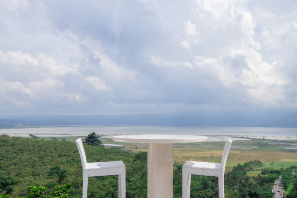 istock Empty white chair and table with beautiful background and cloudy sky. 1458441226