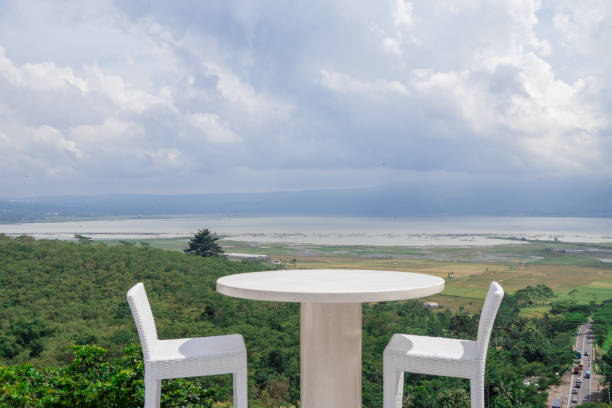 istock Empty white chair and table with beautiful background and cloudy sky. 1458441238