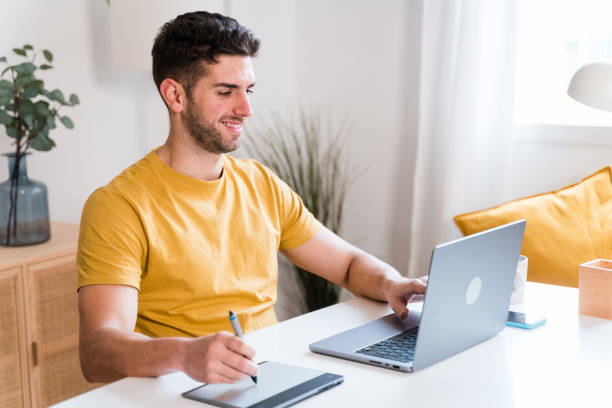 istock Happy man using a tablet to editing photographies 1458447841