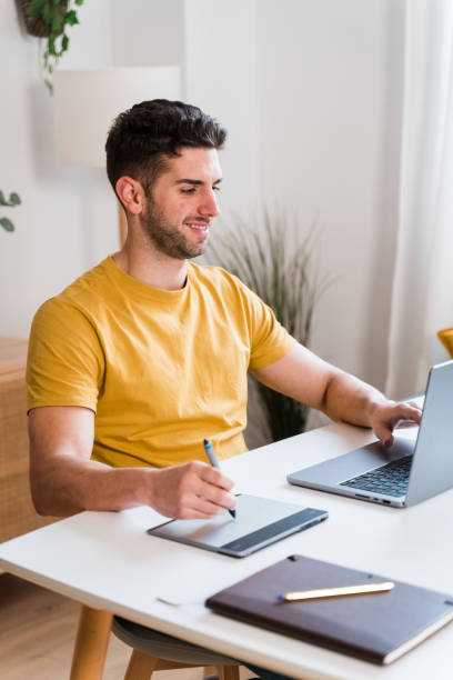 istock Happy man using a tablet to editing photographies 1458447947