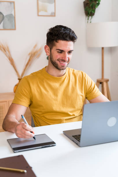 istock Happy man using a tablet to editing photographies 1458448099